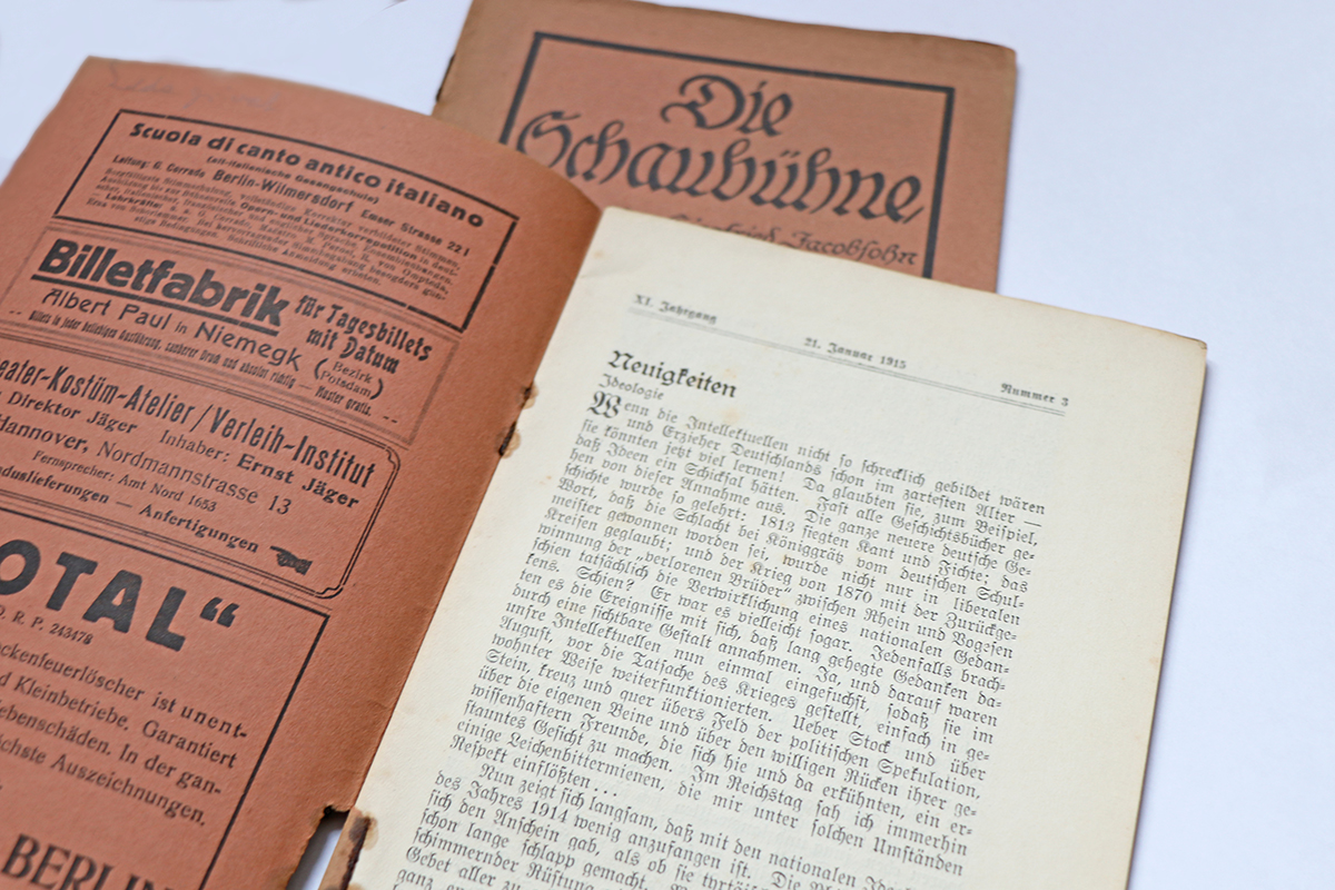 two issues of "Die Schaubühne", one of them opened, showing advertisements on the inside of the cover and news on the first page.