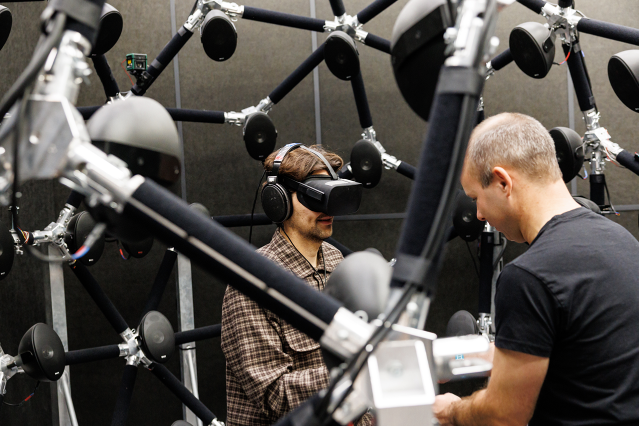 Two male scientists preparing for a listening study in the Loudspeaker Array Studio at the Acoustics Research Institute. 