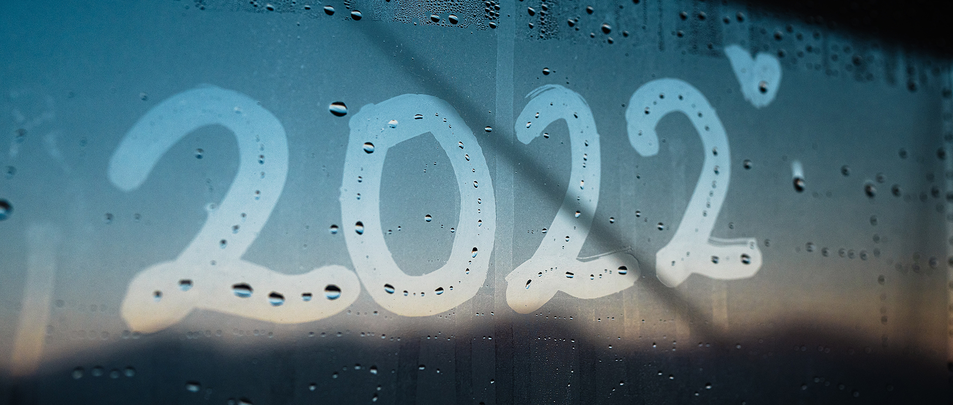 Fensterscheibe mit dem Schriftzug "2022" Beschlagene Fensterscheibe, in die mit den Fingern "2022" geschrieben wurde