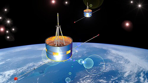 Two drum-shaped satellites with long, thin booms are flying one behind the other in space. In the background, the light-blue globe of Earth, with bands of clouds, is visible beneath a black, star-studded sky.