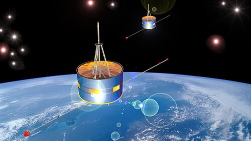Two drum-shaped satellites with long, thin booms are flying one behind the other in space. In the background, the light-blue globe of Earth, with bands of clouds, is visible beneath a black, star-studded sky.
