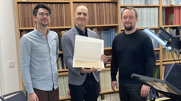 Die Abbildung zeigt die Forscher Paul Gulewycz (ACDH, ÖAW), Johannes Prominczel (GfM) und Clemens Gubsch (ACDH, ÖAW) mit dem digitalisierten Schubert-Autograph