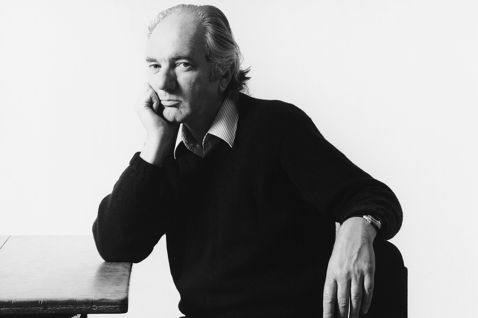 portrait of Thomas Bernhard, sitting and leaning against a table