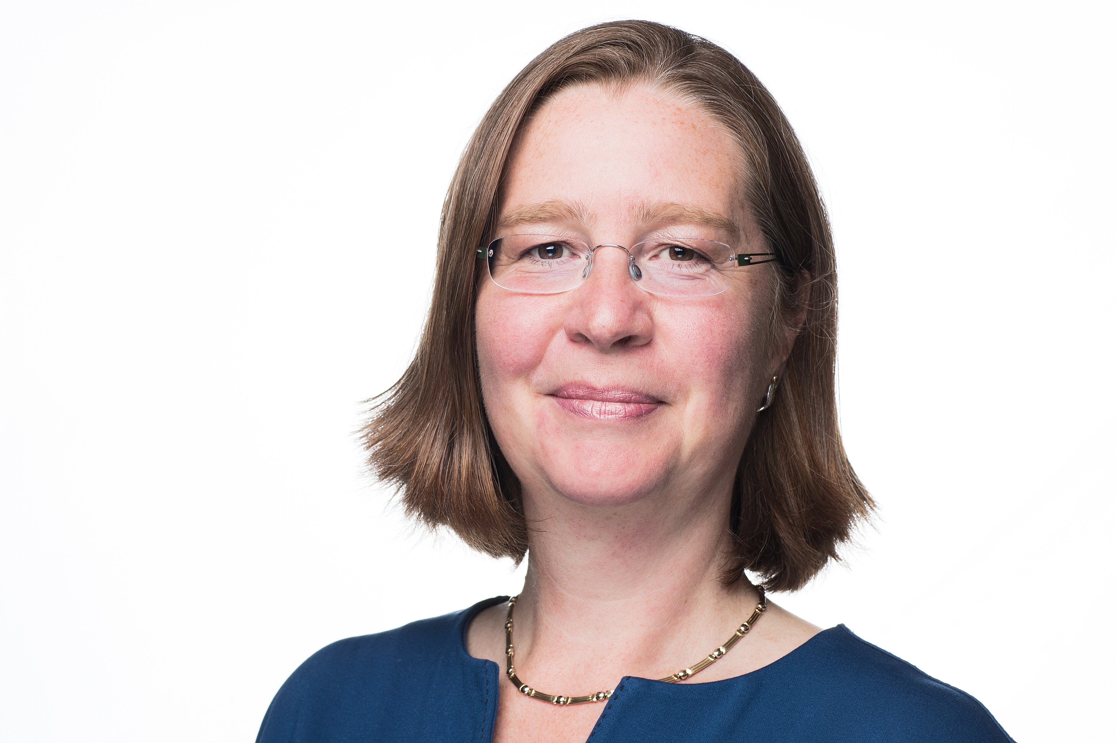 A professional portrait photo of Prof. Dr. Christiane Helling. She is smiling at the camera.